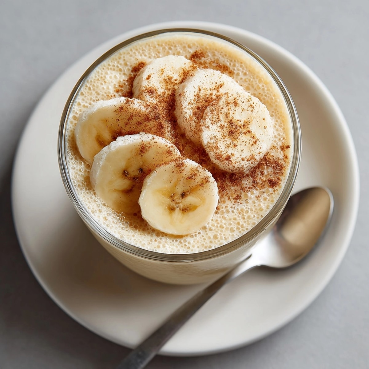 Thick, frothy peanut butter banana smoothie blending ripe bananas and nutty sweetness, ready to enjoy.