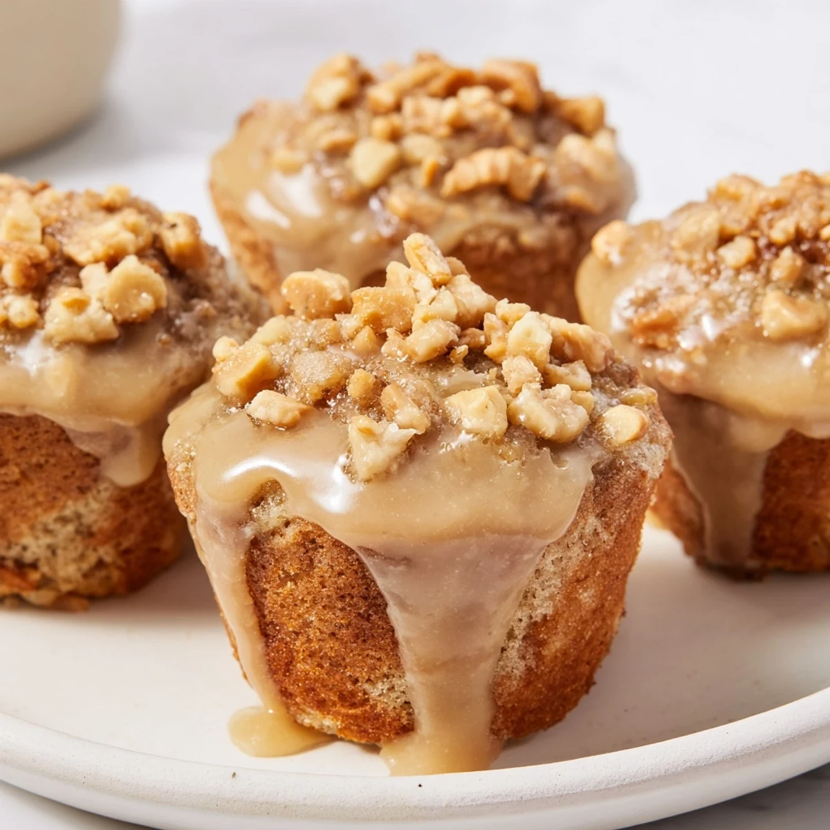 Soft Maple Glazed Pretzel Cake Muffins drizzled with sweet glaze and pretzel crunch.  