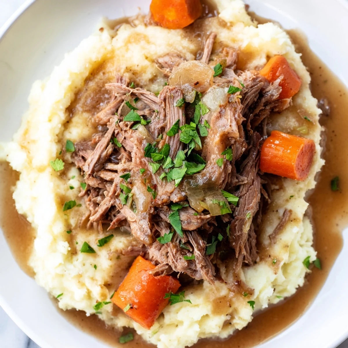 Tender Slow Cooker Pot Roast pictured, served with creamy mashed potatoes and flavorful gravy.