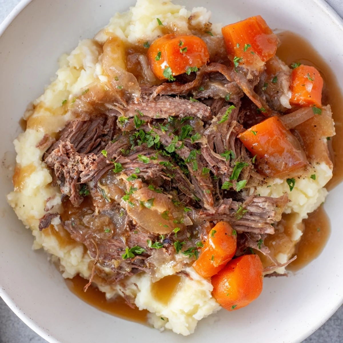 A delicious, steaming bowl of Slow Cooker Pot Roast, perfect for a cozy Sunday dinner.