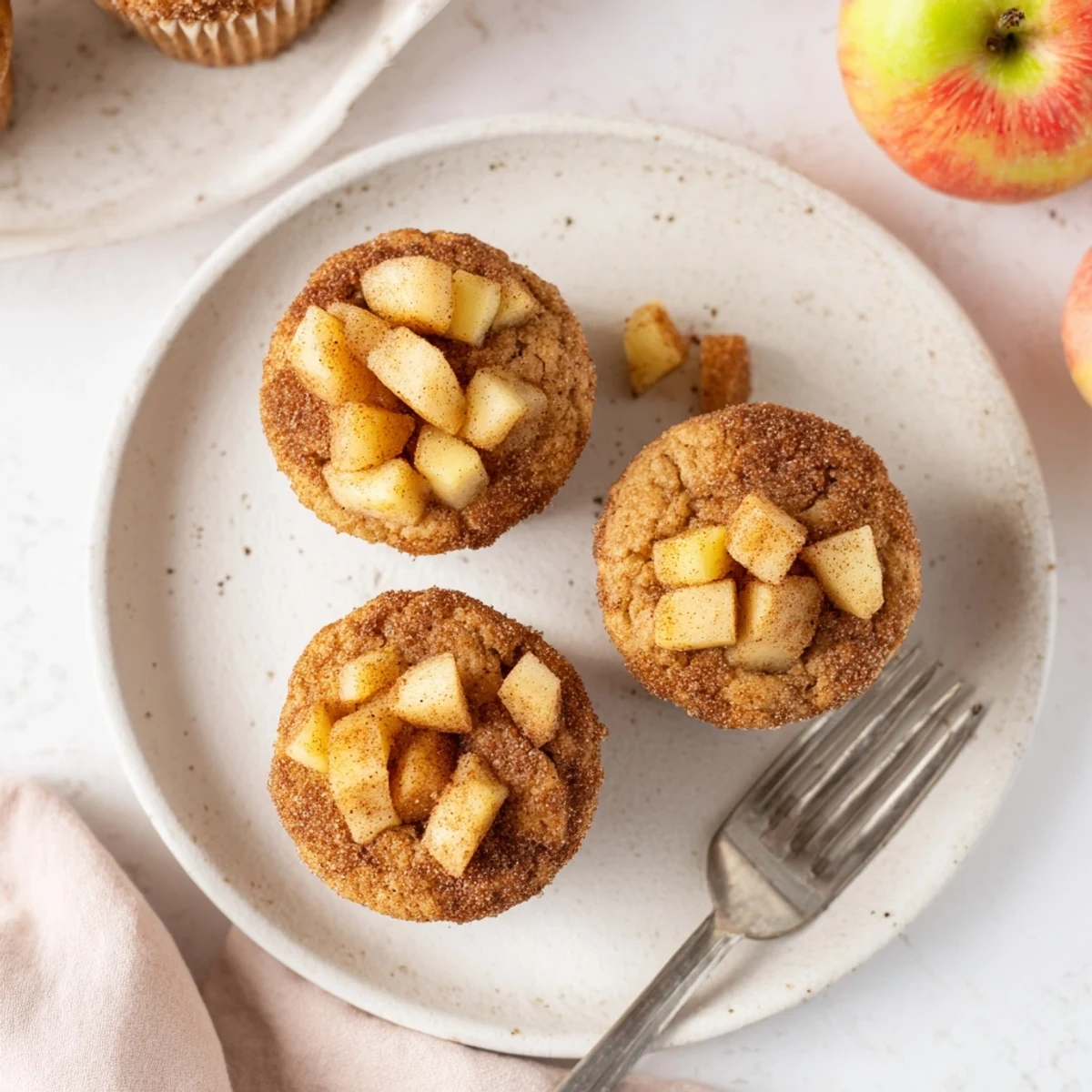 Freshly baked cinnamon apple muffins, with a sweet crumb topping, promising a delightful treat.