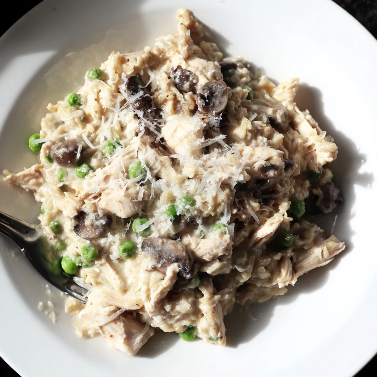 Slow-cooked Creamy Chicken Alfredo, a steaming bowl of pasta covered in rich, savory sauce.