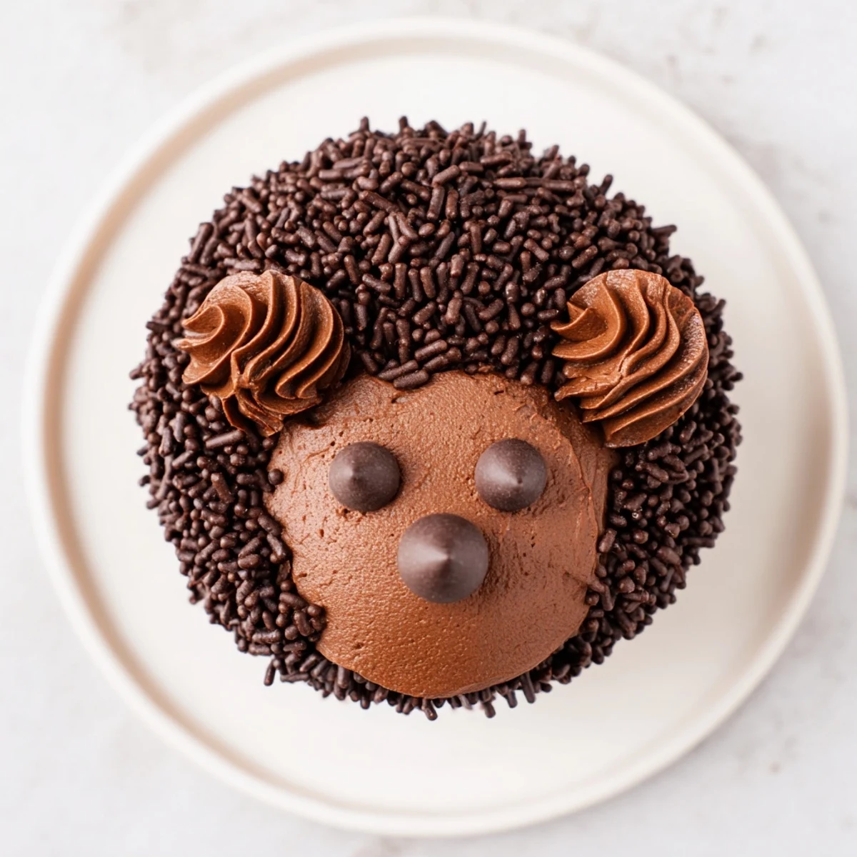 Close-up on a charming hedgehog cupcake tower, showcasing chocolate sprinkles and almond spikes.