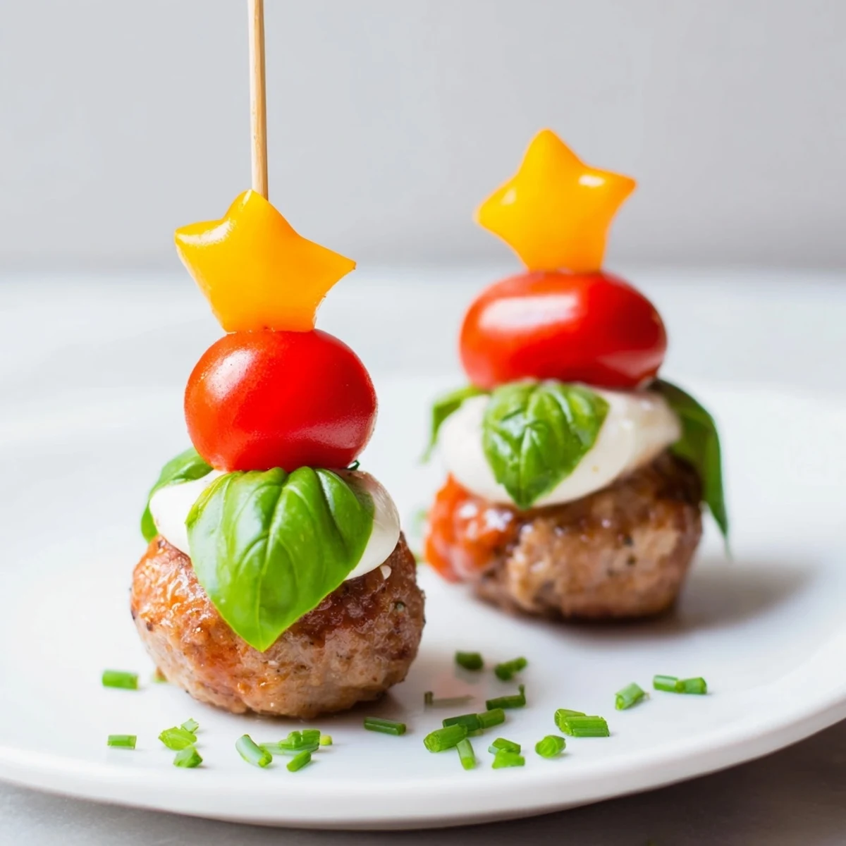 Savory Mini Meatball Christmas Trees ready to be devoured, with fresh basil and cherry tomatoes as cheerful decorations.