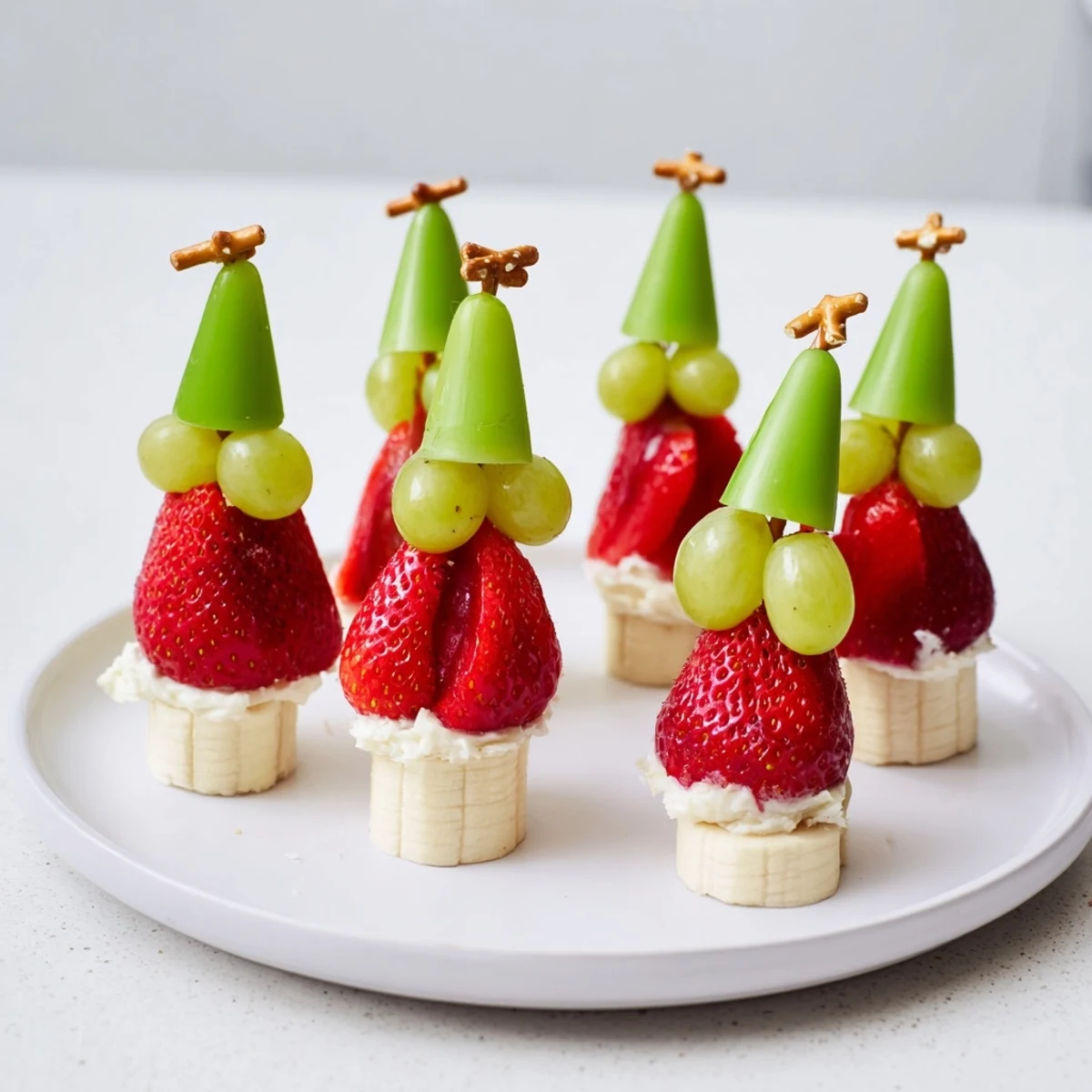 Sweet Elf Hat Strawberry Skewers boast vibrant red strawberries and banana slices, a fun, festive treat.
