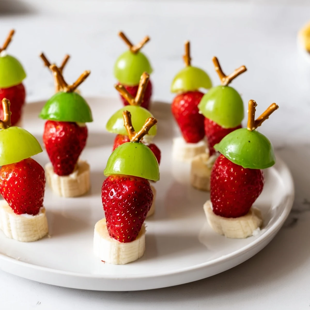 These simple Elf Hat Strawberry Skewers showcase fresh strawberries, grapes, an easy kids' snack idea.