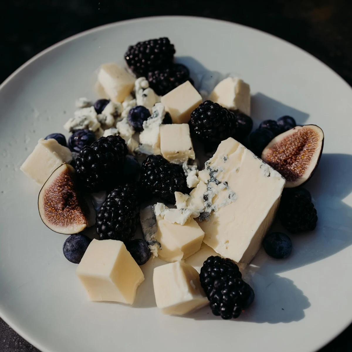 Deep Indigo Midnight Sky cheese board, fruits and cheeses, offers a stunning, delicious appetizer with crackers.