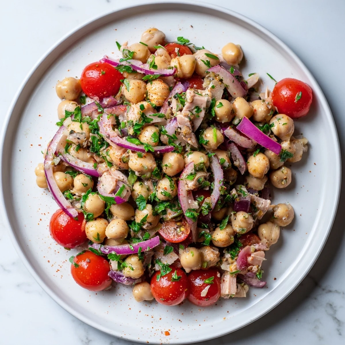 Creamy, vibrant Dense Chickpea and Tuna Salad with bright red onion and parsley, ready to enjoy.