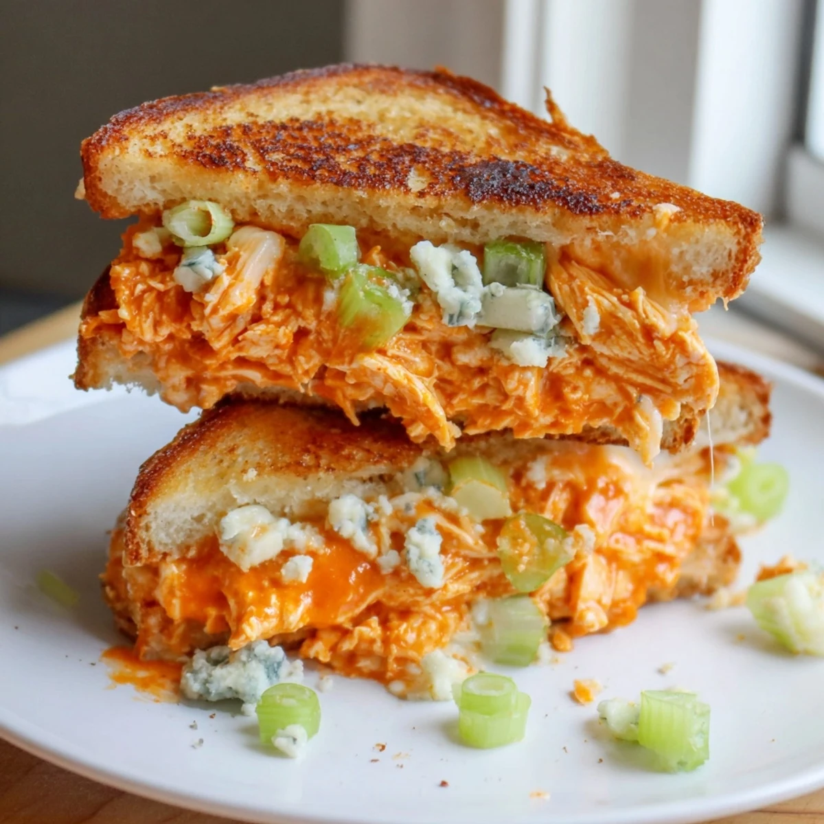 A close-up of a perfectly grilled Buffalo Chicken Grilled Cheese sandwich, hot and ready to eat.