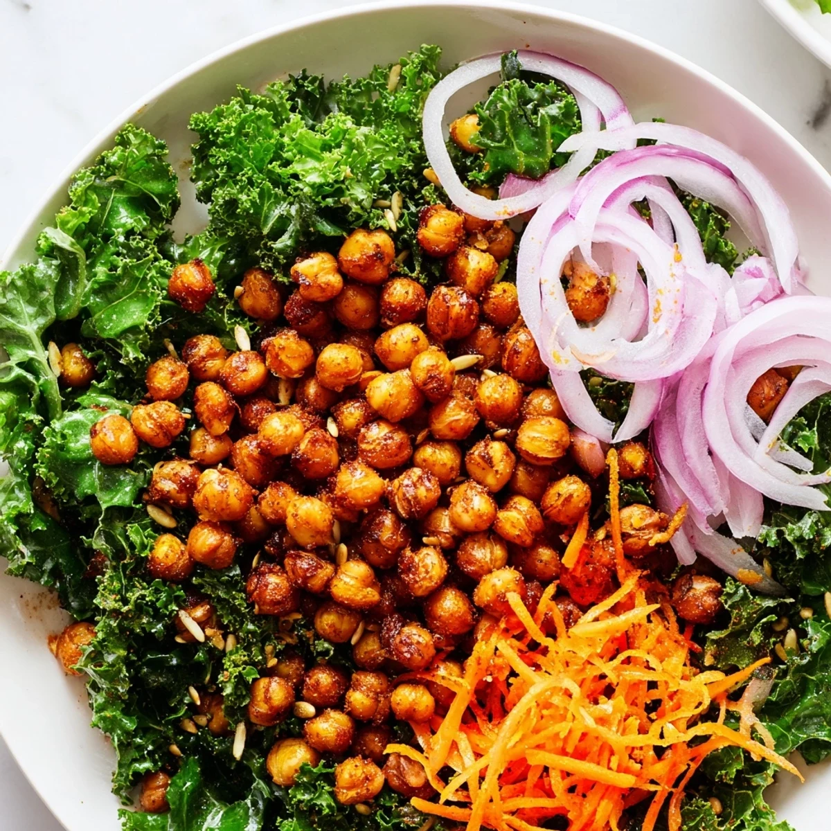 This kale salad with roasted chickpeas shows savory spiced chickpeas atop tender, massaged kale greens.