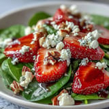 Sweet strawberries and baby spinach tossed with crunchy nuts, topped with tangy balsamic vinaigrette for a refreshing spring salad.  
