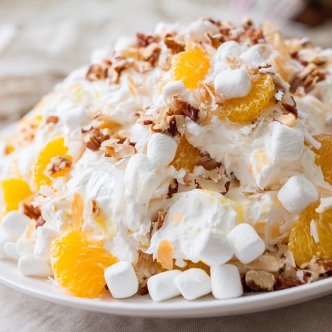 Fluffy, creamy Elevated Ambrosia Salad, with mandarin oranges and pecans, ready to chill and enjoy.