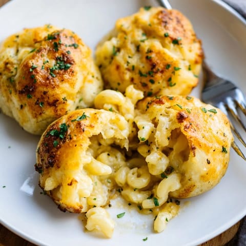 Warm, comforting Mac and Cheese Garlic Dough Balls, served on a plate with parsley garnish.