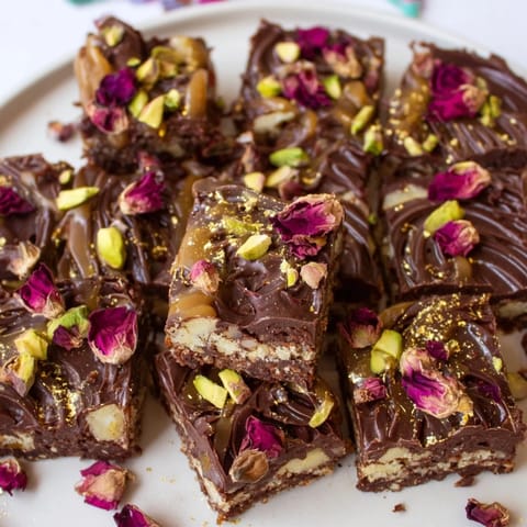 Rich layers of Chocolate Bar Inspired Creations with crunchy texture and edible gold accents.  