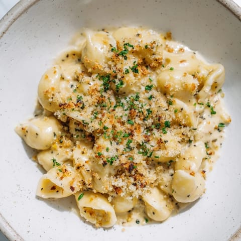 Rich and creamy Truffle Macaroni & Cheese, garnished and awaiting its taste test in a baking dish.