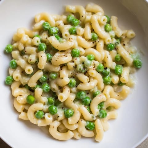 Close-up of Macaroni & Peas: tender pasta with sweet peas and Parmesan cheese.