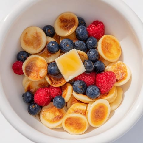 Warm, golden-brown pancake cereal in a bowl, perfect for a fun, shareable breakfast moment.