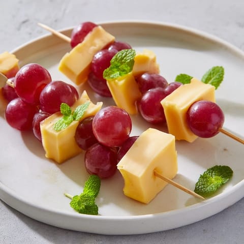 Easy-to-make Cheese & Grape Skewers, a delightful party snack with a sweet and savory balance.