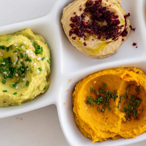 A platter overflowing with Dip Trio dips, perfect for sharing at your next gathering.