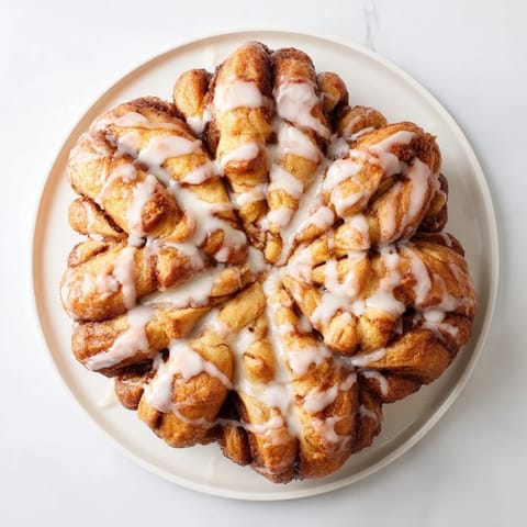 Golden-baked Cinnamon Roll Pull-Apart Snowflake, a visually stunning treat perfect for sharing this winter.