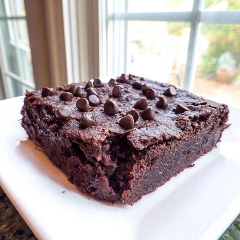 Close-up of moist, dark Black Bean Brownies, showcasing a healthier dessert's rich texture.