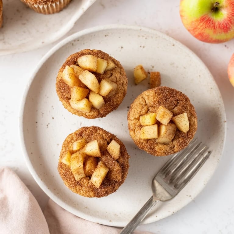 Freshly baked cinnamon apple muffins, with a sweet crumb topping, promising a delightful treat.