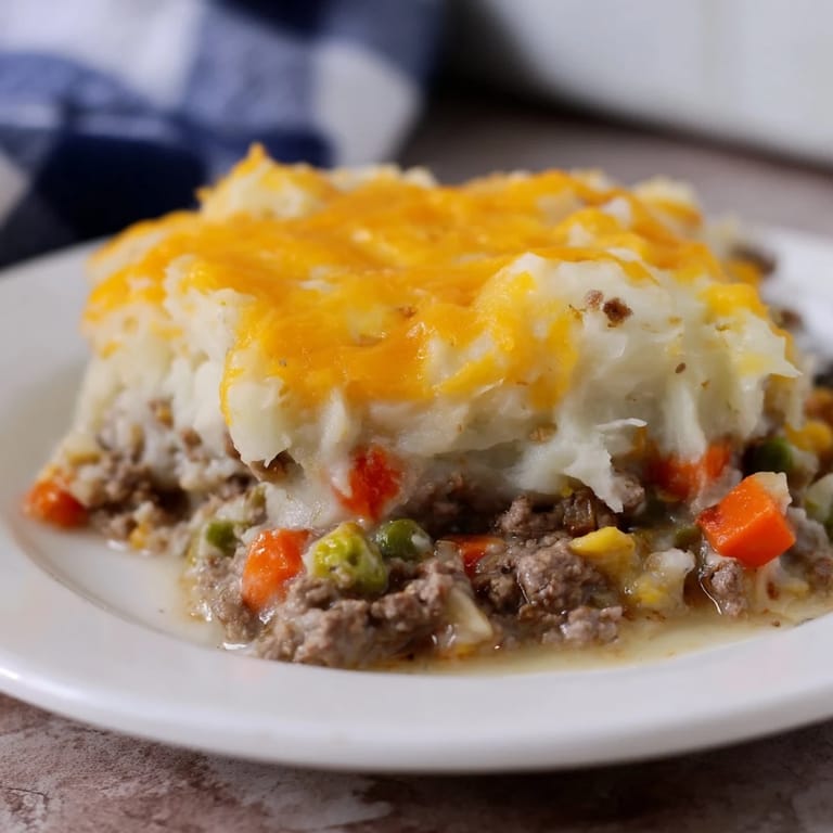 Hearty Budget Shepherds Pie with a cheesy mashed potato topping, baked until beautifully golden.