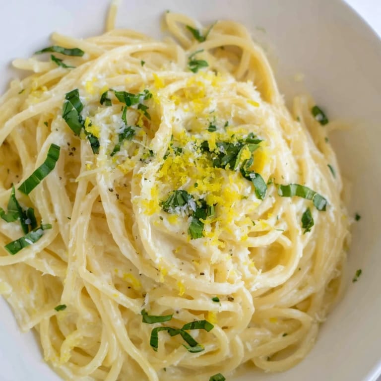 Serving suggestion for Lemon Ricotta Pasta alongside a glass of crisp white wine, perfect for a light weeknight dinner.